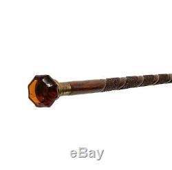 An Antique American Tramp Art Style Carved Amber Glass Mounted Walking Stick Can