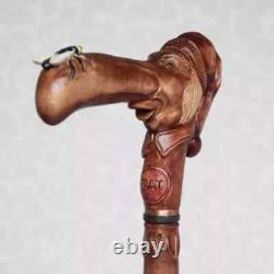 Walking cane Man in stocking cap with fly on the nose Hand carved walking stick